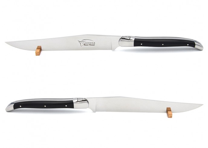 Laguiole carving knife with shiny stainless steel bolsters. Slim black corian handle