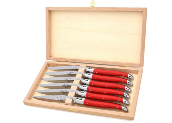 Laguiole steak knives. Slim red Corian handles with shiny stainless steel bolsters. Dishwasher safe