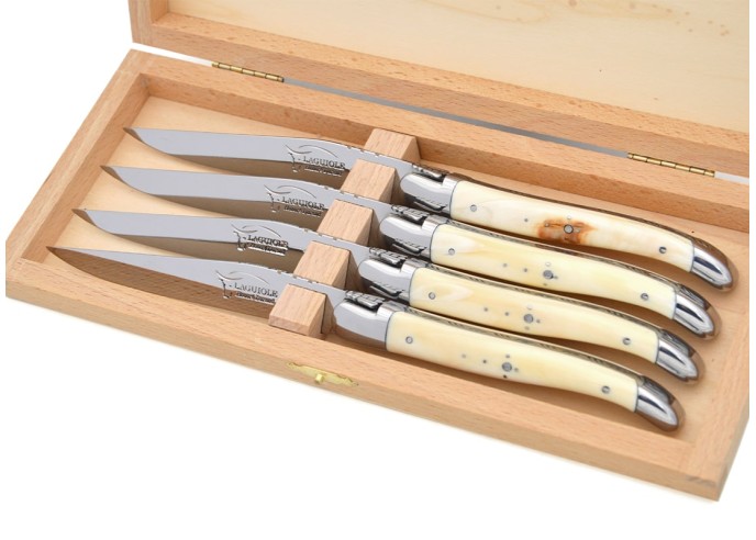 Laguiole steak knives with shiny stainless steel bolsters. Wide dark horn tip handles