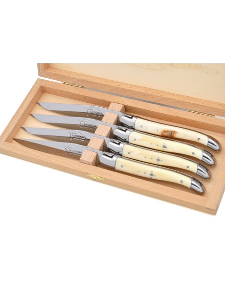 Laguiole steak knives with shiny stainless steel bolsters. Wide dark horn tip handles