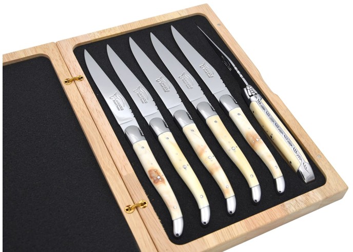 Laguiole steak knives with shiny stainless steel bolsters. Wide dark horn tip handles