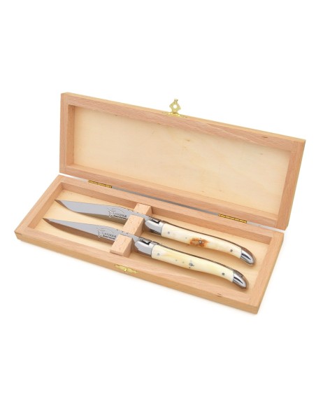 Laguiole steak knives with shiny stainless steel bolsters. Wide dark horn tip handles